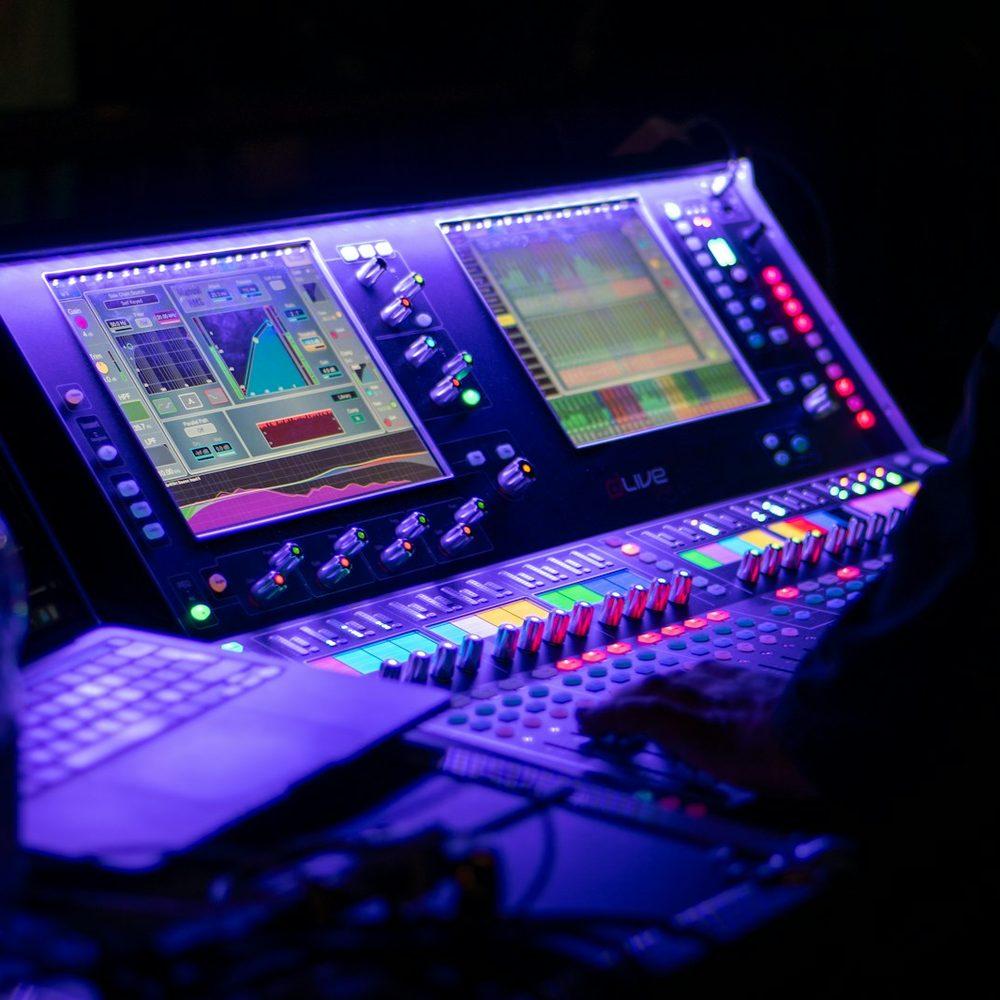 Sound engineer operating a mixing console