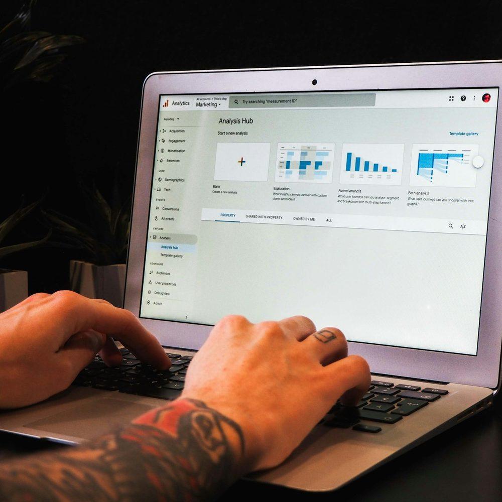 Podcaster reviewing charts on a laptop